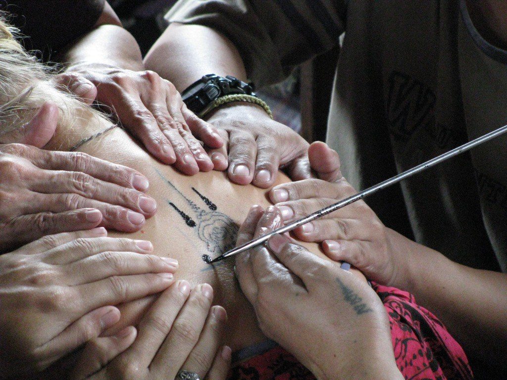 Foreign devotee receiving sak yant tattoo. Amanda Roberts/Creative Commons