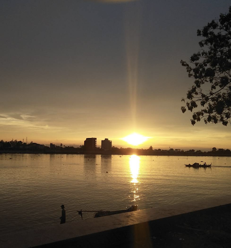 Here the sun sets over the Tonle Sap River just before it meets the Mekong River.